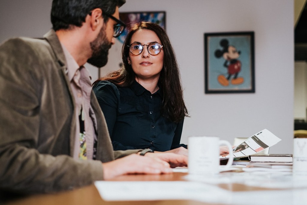 Man and woman collaborating at table demonstrating emotional intelligence in leadership