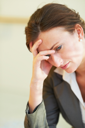 Overwhelmed professional woman at work